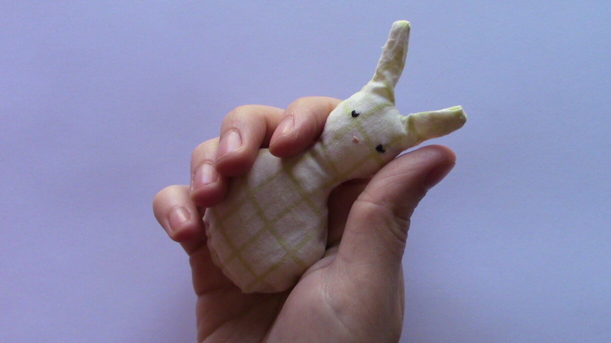 handsewn pocket sized cream and white patterned stuffed rabbit
