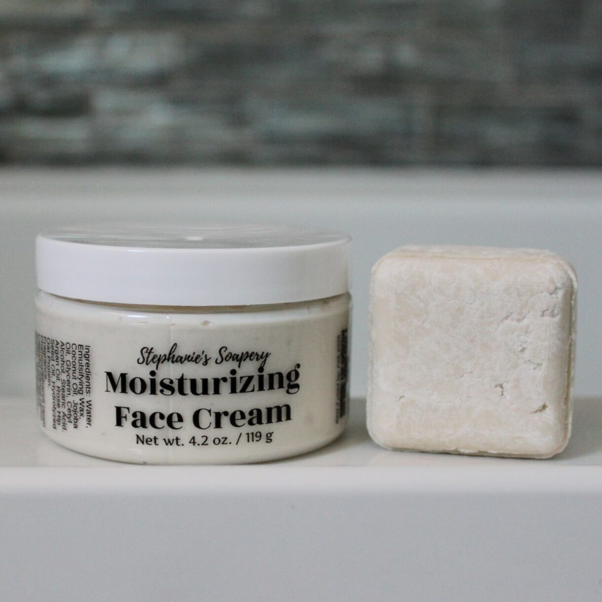 Jar of face cream and a face cleansing bar