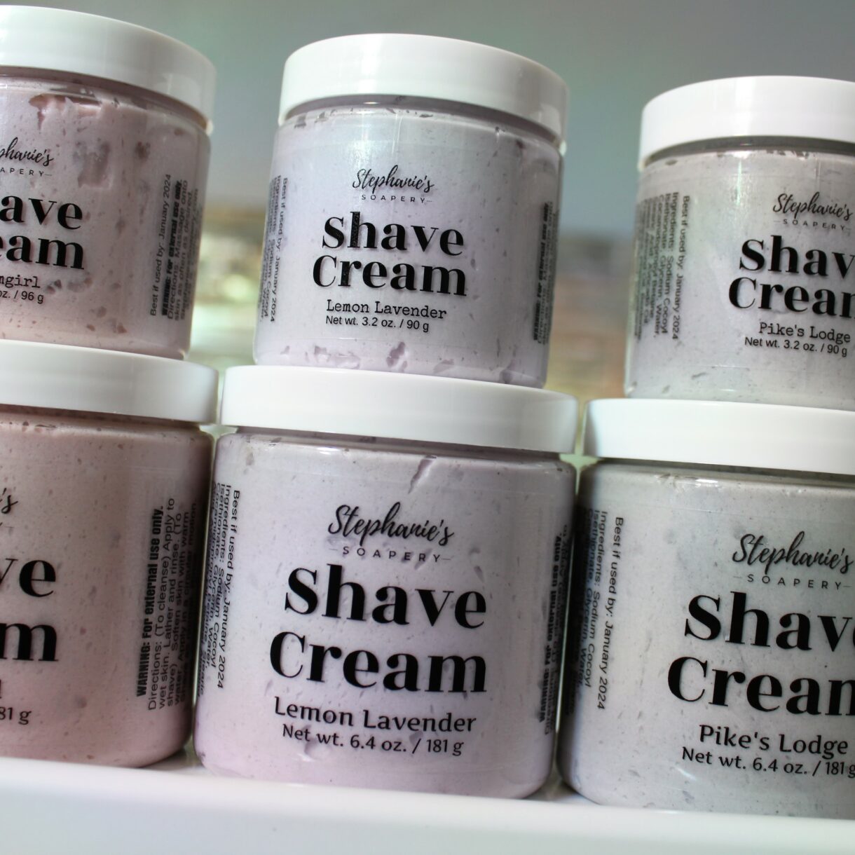 Colorful jars of handcrafted shave cream