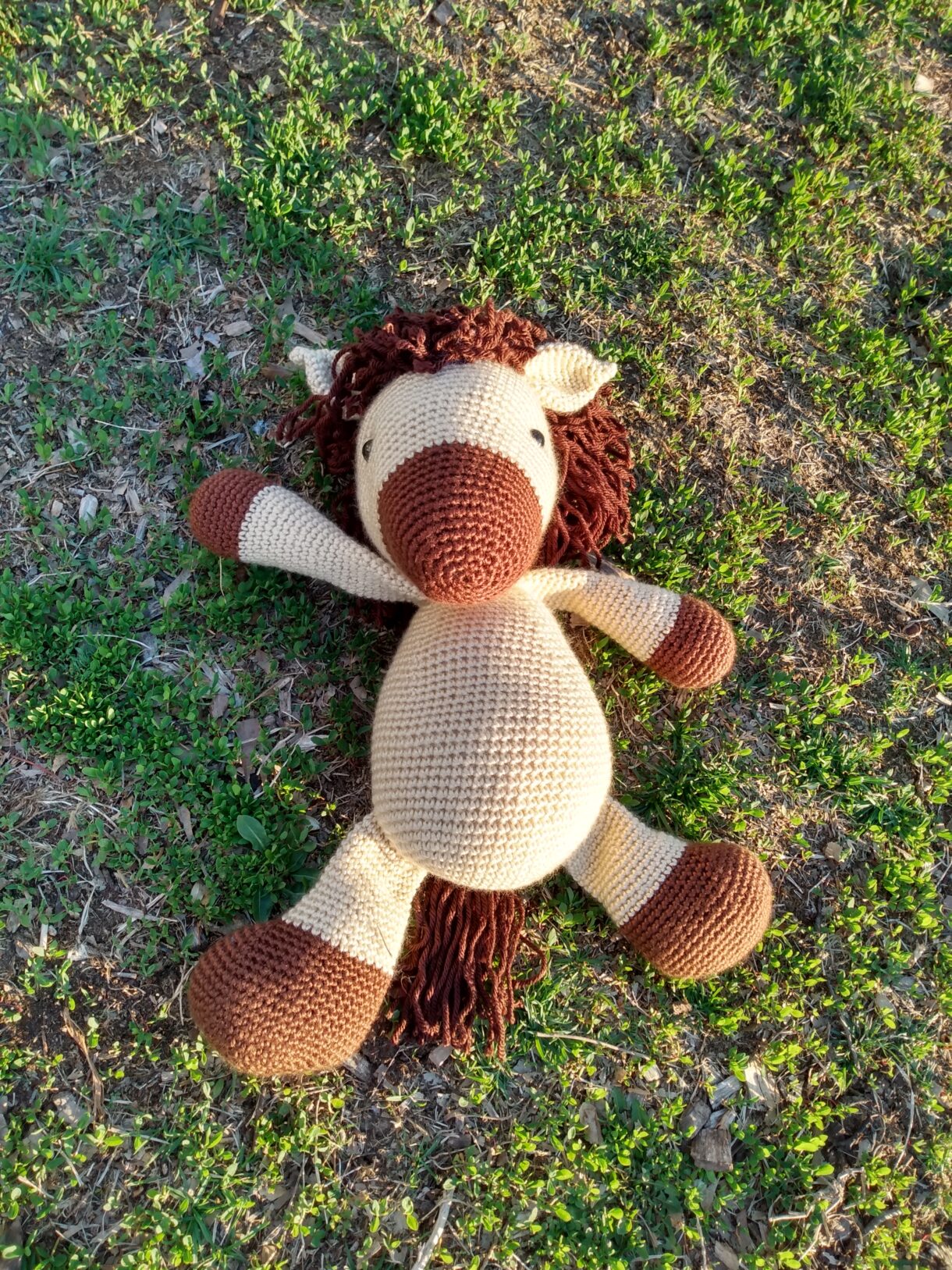 Stuffed brown horse laying