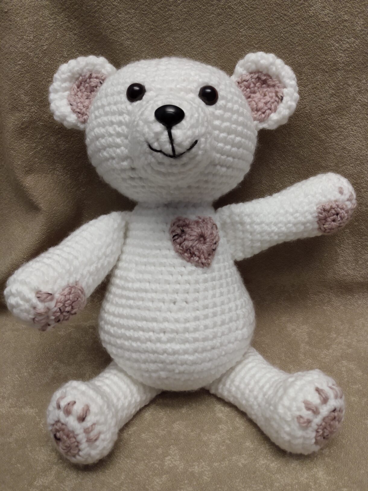 White and pink bear sitting arm outstretched