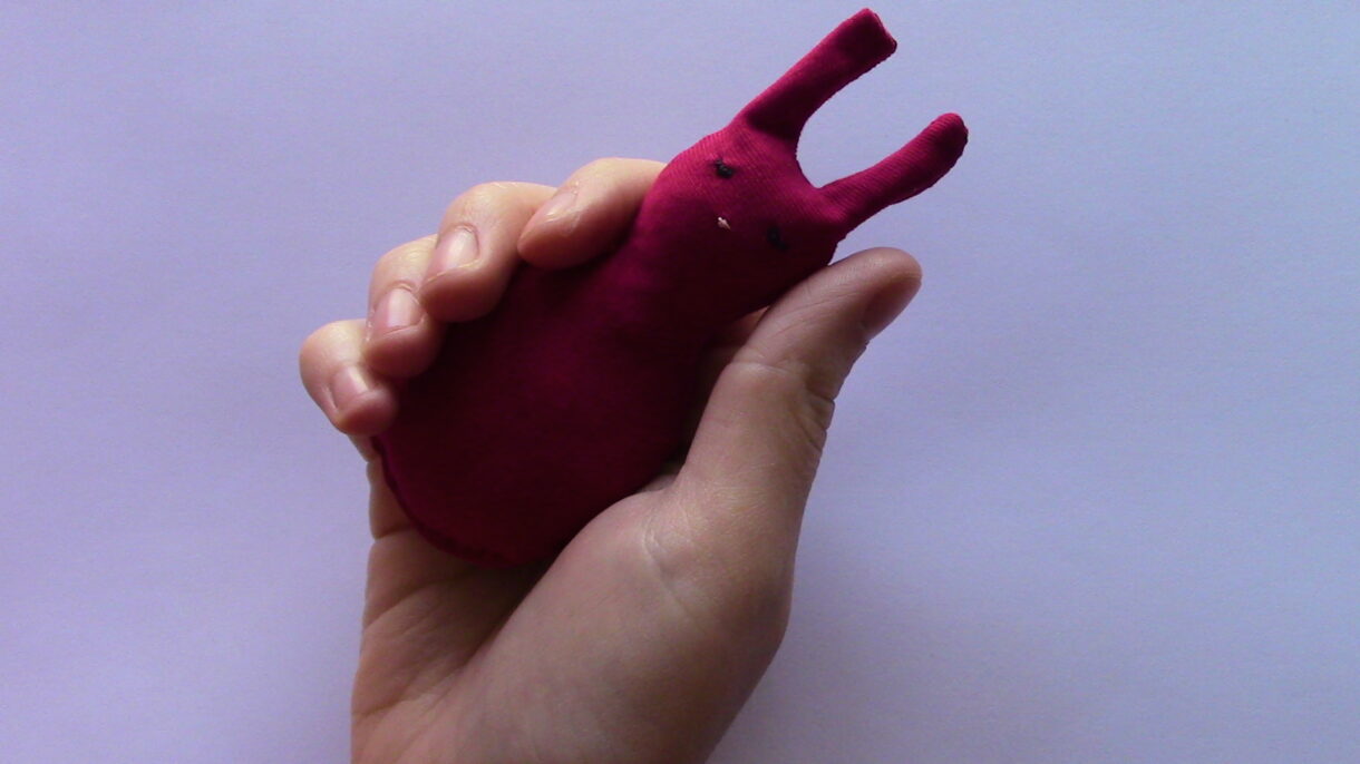 hand sewn pocket sized stuffed red rabbit