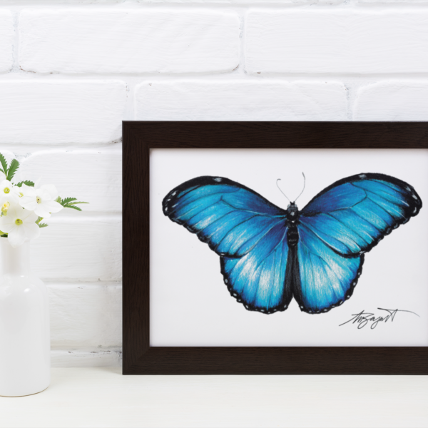 Blue butterfly fine art print in frame sitting on table