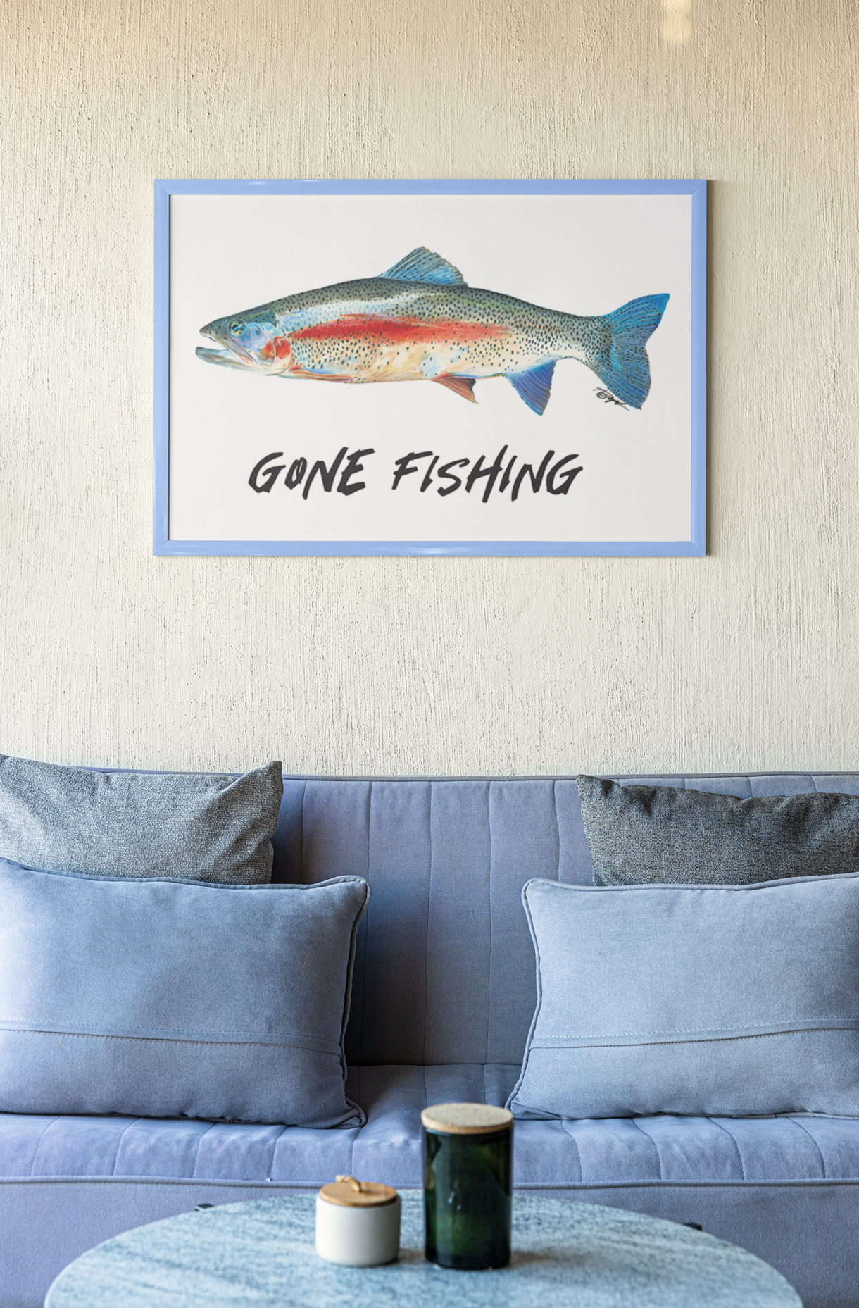 Rainbow trout fine art print in blue frame hanging over couch